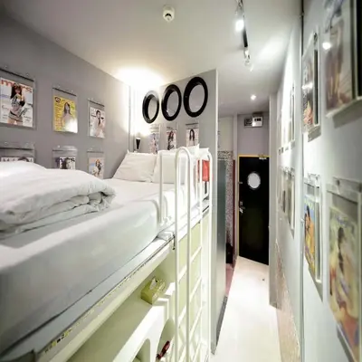 a hospital room with a bed and pictures on the walls at Collection O Jasaen Stylish Unique Hotel in Bangkok