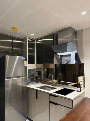 a kitchen with a sink and a stainless steel refrigerator at Luxury condominium Heart of BKK Ekkamai in Bangkok