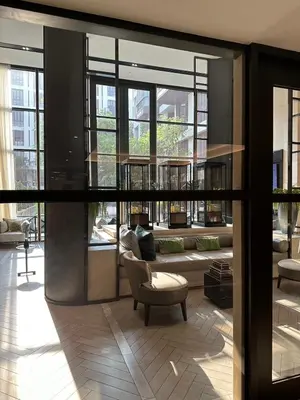 a lobby with a chair and a room with windows at Luxury condominium Heart of BKK Ekkamai in Bangkok