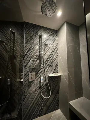 a bathroom with a shower with a glass door at Luxury condominium Heart of BKK Ekkamai in Bangkok