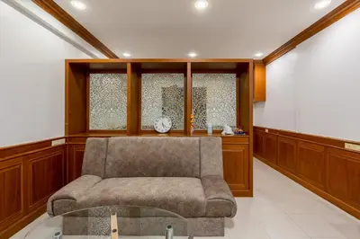 a living room with a chair and a window at White Base in Bangkok
