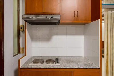 a kitchen with a stove and a counter top at White Base in Bangkok
