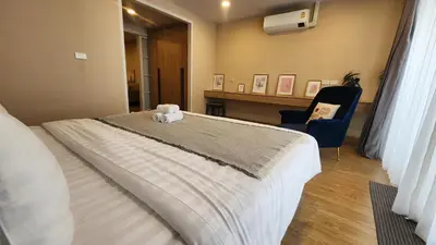 a bedroom with a bed and a desk and a chair at Floating Above Bangkok Same buiding of Lebua High Floor Dream near Iconsiam Asiatique in Bangkok