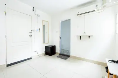 a white room with a shower and a door at XX Oh My Nap Nana Soi 3 - BTS Nana in Bangkok