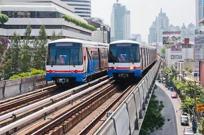 two trains on the tracks in a city at XX Yon INN Sukhumvit Soi 4 - BTS Nana in Bangkok