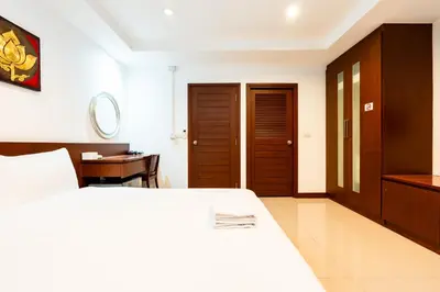 a bedroom with a bed and a desk and a table at XX Yon INN Sukhumvit Soi 4 BTS Nana in Bangkok