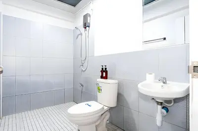 a white bathroom with a toilet and a sink at xx Yellow Place Sukhumvit Soi 2 - เยลโล เพลส สุขุมวิทซอย 2 in Bang Kapi