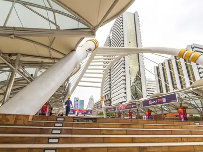 a man standing on stairs in front of a city at Studio room with private garden in Center Sathorn in Bangkok