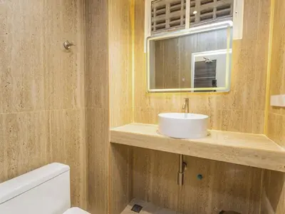 a bathroom with a white sink and a mirror at Studio room with private garden in Center Sathorn in Bangkok