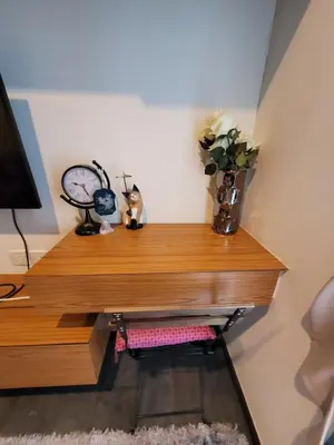 a wooden shelf with a vase of flowers on it at Downtown Luxury Apartment, Asok Cowboy Lane, 400m from BTS in Bangkok