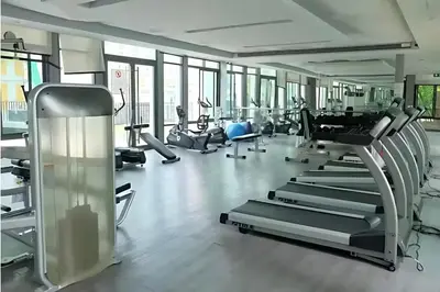 a gym with treadmills and elliptical machines at Skyline View 1 Bedroom Near RCA, Thonglor And Nana in Bangkok
