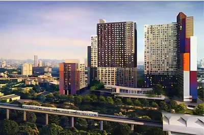 a city with a train in front of tall buildings at Skyline View 1 Bedroom Near RCA, Thonglor And Nana in Bangkok