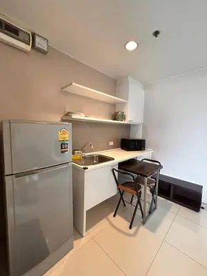 a small kitchen with a sink and a refrigerator at Skyline View 1 Bedroom Near RCA, Thonglor And Nana in Bangkok