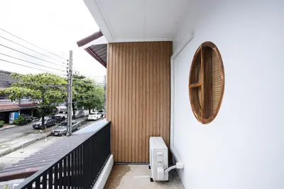 a building with a balcony with a mirror on the wall at Urban Muji Oasis Ratchada-Lat Phrao Chatuchak MRT in Bangkok
