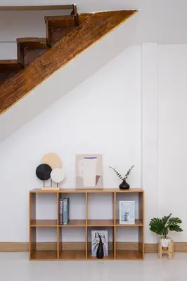 a living room with a book shelf under a loft at Urban Muji Oasis Ratchada-Lat Phrao Chatuchak MRT in Bangkok