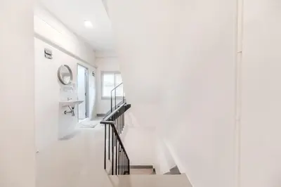 a staircase in a white room with a sink and a mirror at Bangkok Group Haven - 6BR Bangchak BTS 12 sleeps RB4 in Amphoe Phra Khanong
