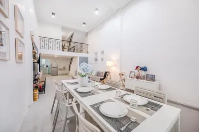 a white room with a table with white plates on it at Bangkok Group Haven - 6BR Bangchak BTS 12 sleeps RB4 in Amphoe Phra Khanong