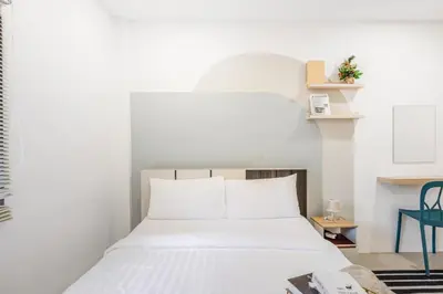 a bedroom with a bed with white sheets at Bangkok Group Haven - 6BR Bangchak BTS 12 sleeps RB4 in Amphoe Phra Khanong