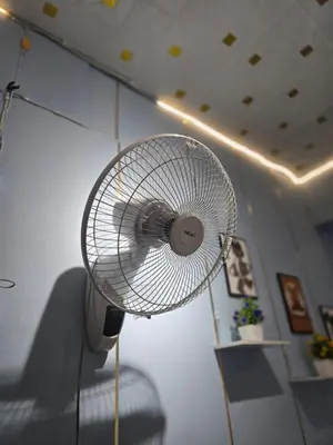 a white fan is hanging on a wall at 100 Luxury Studio Apartment with private balcony in Bangkok