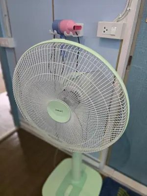 a white fan is sitting in a room at 100 Luxury Studio Apartment with private balcony in Bangkok