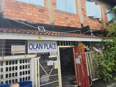a sign that reads olean place in front of a building at 100 Luxury Studio Apartment with private balcony in Bangkok