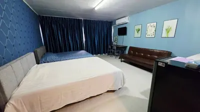 a bedroom with a bed and a couch in it at อิมแพ็ค เมืองทองธานี ห้องเช่ารายวัน เมืองทอง popular condo C4 in Nonthaburi