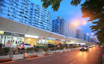 a city street with cars parked in front of buildings at อิมแพ็ค เมืองทองธานี ห้องเช่ารายวัน เมืองทอง popular condo C4 in Nonthaburi