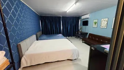 a bedroom with a bed and a couch in it at อิมแพ็ค เมืองทองธานี ห้องเช่ารายวัน เมืองทอง popular condo C4 in Nonthaburi