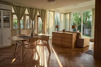a living room with a table and a couch at Baan Suanpak in Bangkok