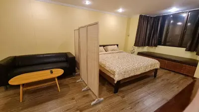 a small bedroom with a bed and a couch at Comfort 1BR 2 King Beds, Best Value Stay, near Bts Nana in Bangkok