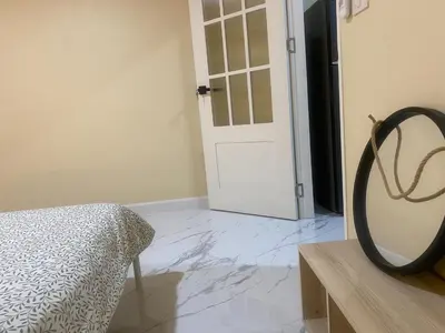 a bedroom with a white door and a marble floor at 1 Bed Nr IKEA 15Mins to Airport in Bangkok