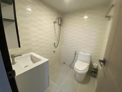 a white bathroom with a toilet and a sink at 1 Bed Nr IKEA 15Mins to Airport in Bangkok