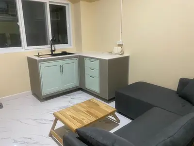 a living room with a couch and a table at 1 Bed Nr IKEA 15Mins to Airport in Bangkok