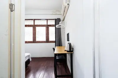 a room with a table with a telephone on it at XX GO INN Siriraj Wang Lang - โก อินน์ โรงพยาบาลศิริราช วังหลัง in Bangkok