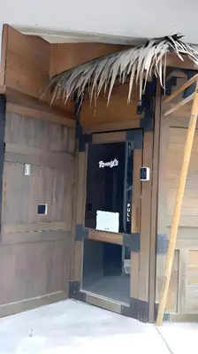 a building with a garage with a door and a window at xx GO INN BTS Ari - โกอินอารีย์ in Bangkok