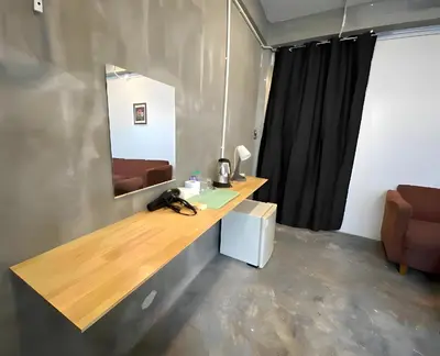 a bathroom with a counter with a mirror and a sink at xx GO INN BTS Ari - โกอินอารีย์ in Bangkok