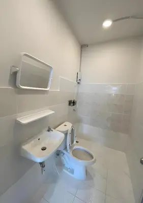 a white bathroom with a toilet and a sink at xx GO INN BTS Ari - โกอินอารีย์ in Bangkok