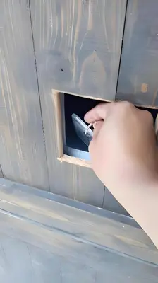 a hand is opening a drawer in a cabinet at xx GO INN BTS Ari - โกอินอารีย์ in Bangkok