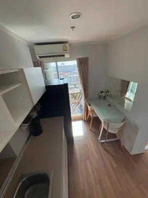 a small kitchen with a table and a dining room at Minimalist Condo in Pinklao in Bangkok