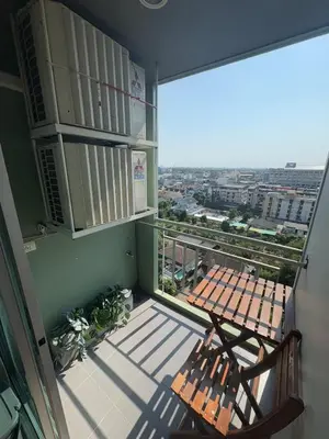 a balcony with a bench and a view of a city at Minimalist Condo in Pinklao in Bangkok