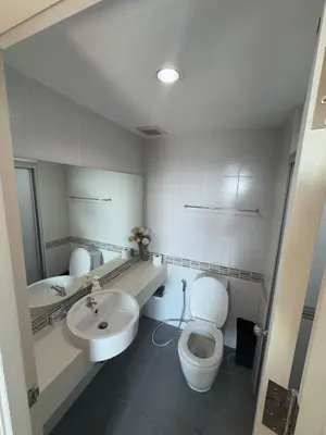 a bathroom with a toilet and a sink at Minimalist Condo in Pinklao in Bangkok