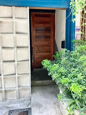 a door leading into a house with plants at Bali Style Rooftop Apartment in Bangkok