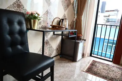 a black chair in a room with a table and a window at SKY 21 Colorful Room with Soaring View Center BKK in Bangkok