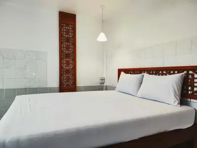 a bedroom with a large bed with white pillows at Tropical Apartments 1 No Stairs easy peasy in Bangkok