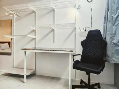 a black chair sitting next to a desk in a room at Tropical Apartments 1 No Stairs easy peasy in Bangkok