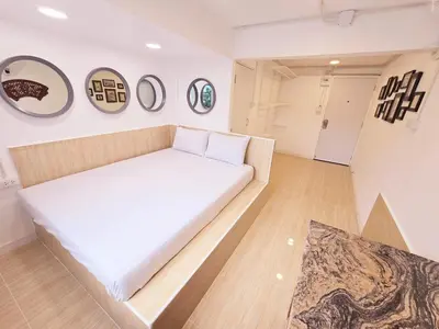 a bed in a room with four pictures on the wall at Crane nest 2 mezzanine opaque view in Bangkok