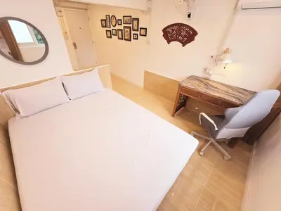 a bedroom with a bed and a desk and a chair at Crane nest 2 mezzanine opaque view in Bangkok