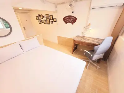 a bedroom with a bed and a desk and a chair at Crane nest 2 mezzanine opaque view in Bangkok