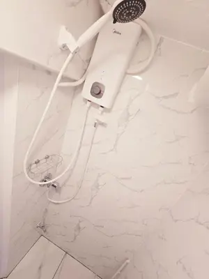 a shower in a bathroom with a hair dryer at Crane nest 4 lower floor in Bangkok