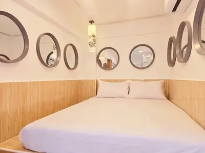a bedroom with round mirrors on the wall at Crane nest 4 lower floor in Bangkok